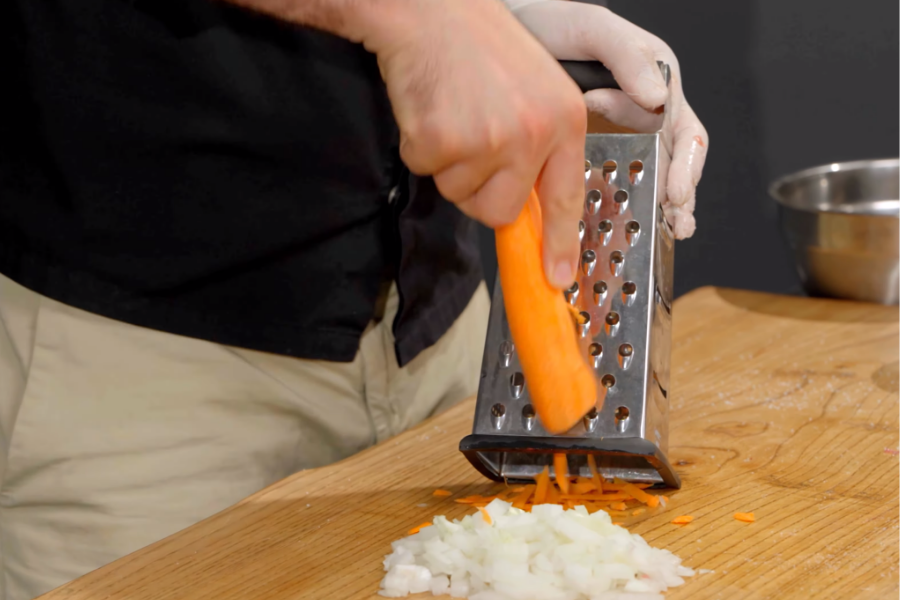 Chopping the onion and grating the carrots