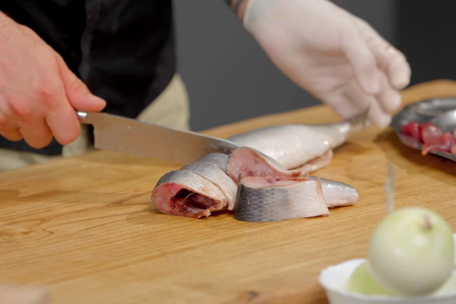 Cutting the herring into pieces